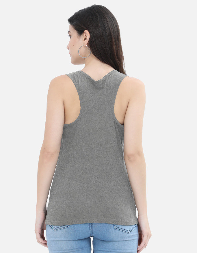 Woman in grey sleeveless top and blue jeans, Nairove Closet modern fashion.