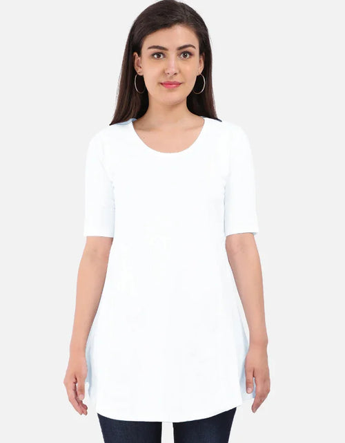 Woman wearing a white half-sleeve tunic top and dark jeans from Nairove Closet