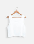 White sleeveless crop top on wooden hanger, Nairove Closet fashion basics collection