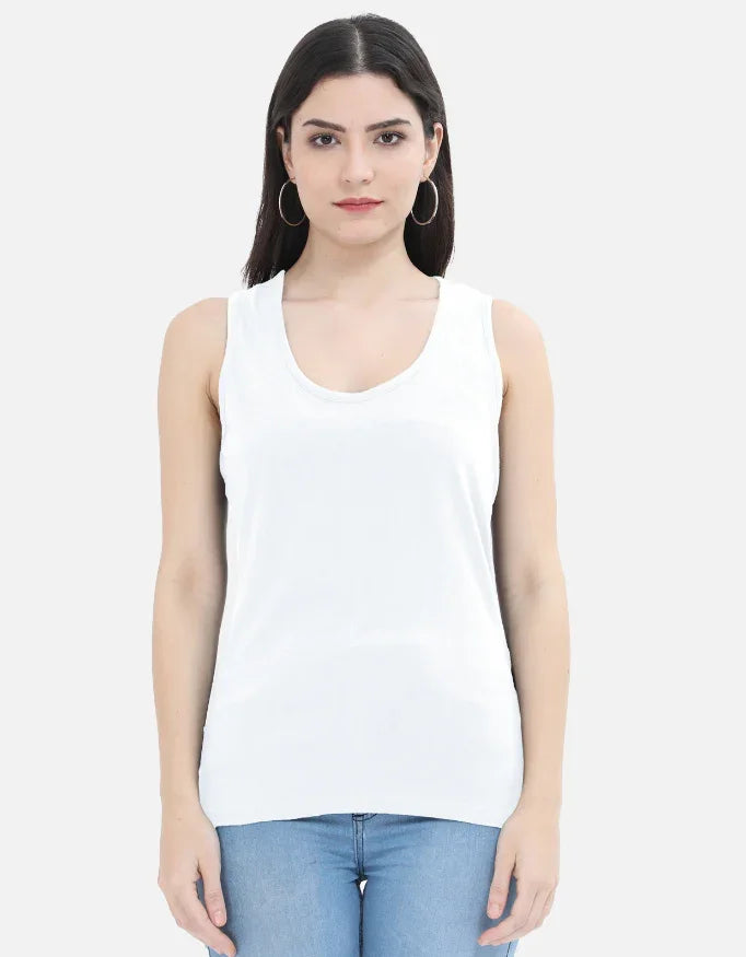 Woman wearing white sleeveless top and blue jeans, Nairove Closet fashion collection
