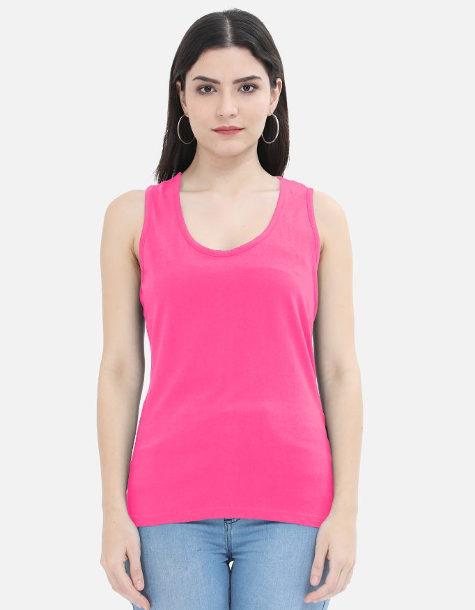 Woman wearing bright pink sleeveless top and blue jeans from Nairove Closet collection